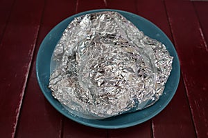 Aluminum foil and bowl on table