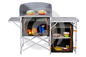 Aluminum folding universal table for camping or for fishing, with a demonstration of use, on a white background