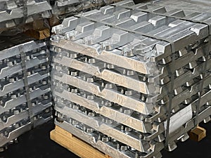 Aluminum ingots stacked on a pallet, raw material, aluminum alloy ready to be processed photo