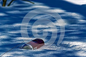 Aluminum jar of beer lies in the snow