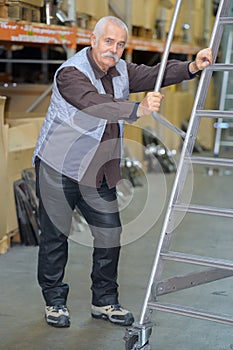 Aluminum ladder indoors at warehouse racks