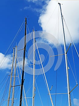 Aluminum masts, spars and rigging of the sailboat against the blue tropical sky. Boats and Navigation