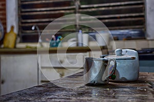 Aluminum mug in an old farm kitchen photo