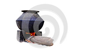 Aluminum pan kept on a earthen oven with wood as fuel at a village in India. White background