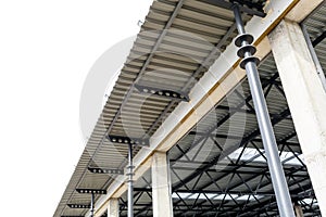 Aluminum roof with windows on a metal frame. Iron columns support the visor. Construction of the hangar