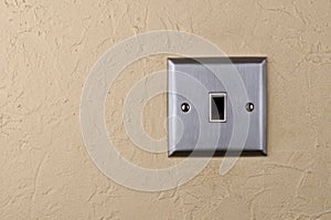 Aluminum switch plate on wall