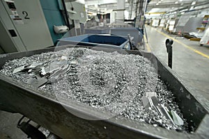 Aluminum waste resulting from pieces of aluminum metal being processed by cutting, cnc processing.