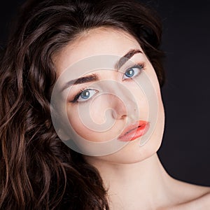 Alyona, serious face with blue contact lenses, black background