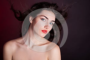 Alyona, serious face with blue contact lenses, red background