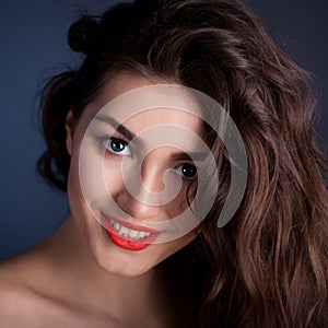 Alyona, smiling face with blue contact lenses, blue background