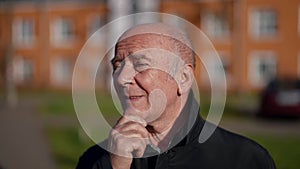 alzheimer patient is standing on street, remembering something, portrait of old man outdoors