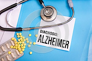 Alzheimer word written on medical blue folder with patient files