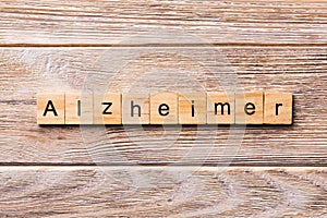 Alzheimer word written on wood block. Alzheimer text on wooden table for your desing, concept