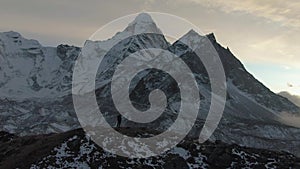 Ama Dablam Mountain and Hiker Man at Sunset. Himalaya, Nepal. Aerial View