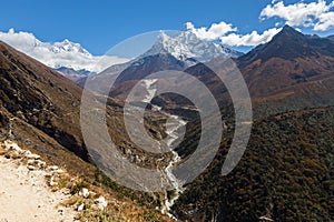 Ama Dablam mountain snow peaks, Pangboche village canyon river.