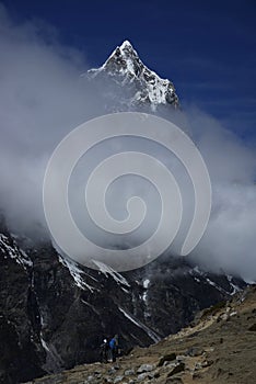 Ama Dablam and trekers in Himalayas