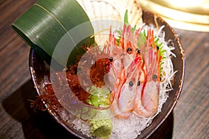 AMAEBI, sweet shrimp or spot prawns, served on ice with red algae seaweed, green tosaka nori and fresh wasabi decorated with green