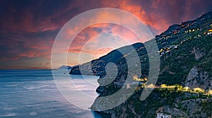 Amalfi Coast, Italy. View over Praiano on the Amalfi Coast at sunset. Street and house lights at dusk. In the distance the island