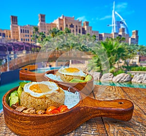 Amaranth porridge with fried eggs in cafe of Souk Madinat Jumeirah, Dubai, UAE