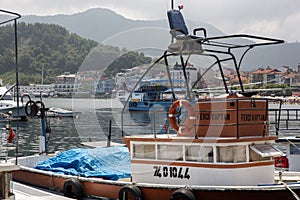 Amasra is a small and charming resort on the Black Sea Coast of Turkey. People swimming in the background, fishing boats, accommo