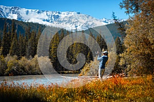 Amateur angler fishing on the rapid river