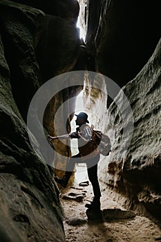 Amateur geologist and speleologist explores a mountain cave. Extreme hobbies