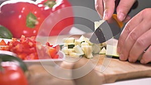 Amateur man cutting vegtables at home.