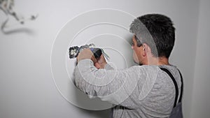 Amateur man with screwdriver setting up outlet