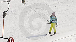 Amateur skier girl on a lift