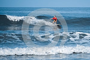 Amateur surfer rides the wave