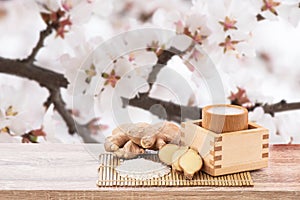 Amazake , sake or rice wine and ginger isolated on cherry blossom background with clipping path