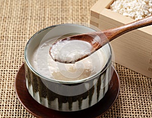 Amazake and a wooden spoon on the table