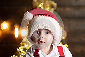 Amazed attractive baby in Christmas costume, close up face.