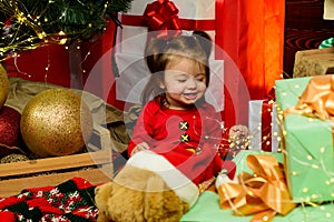 Amazed attractive baby girl in Christmas costume.