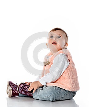 Amazed baby girl looking up studio shot on white