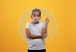 Amazed black boy schooler raising pencil up