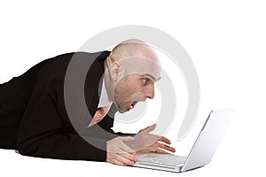 Amazed businessman using laptop