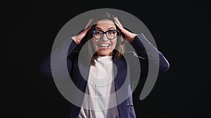 Amazed businesswoman screaming dark background