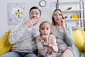 Amazed child holding remote controller near