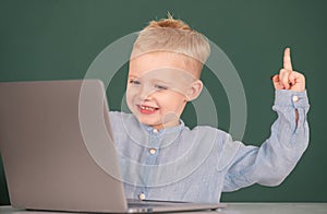 Amazed child using gadgets to study. Computer education for kids. Genius child programming, computer training.