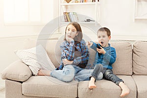 Amazed children watching TV at home