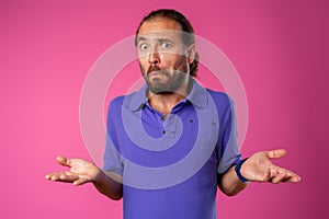 Amazed and confused bearded man looks with astonishment