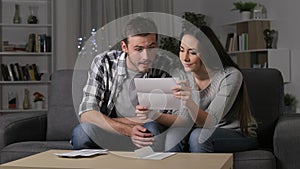 Amazed couple receiving good news on a letter
