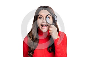 amazed curious teen girl hold magnifying glass isolated on white background.