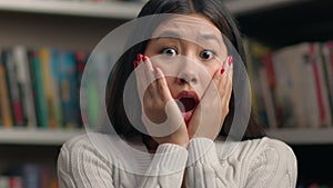 Amazed excited shocked stressed asian woman girl student teacher worried about bad news frightened expression open mouth