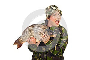 Amazed fisher woman holding big carp