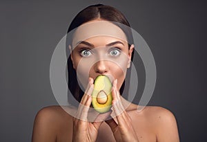 Amazed girl keeping fresh food in hands