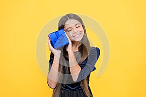 amazed girl kid shopper with happy face holding gift box, christmas