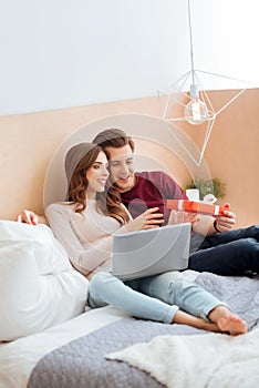 Amazed girl receiving gift from boyfriend