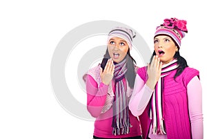 Amazed girls in pink woolen clothes